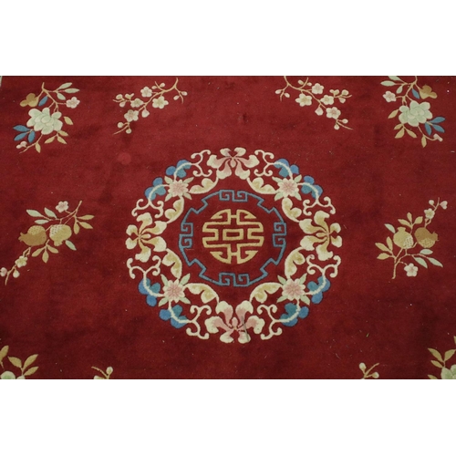 711 - Large Chinese style Red Ground Rug decorated with flowers within a pale green border decorated with ... 