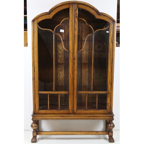 688 - Art Deco Oak Display Cabinet with cloud shaped top, twin glazed doors (a/f) opening to three adjusta... 