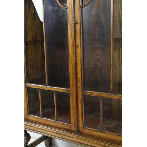 688 - Art Deco Oak Display Cabinet with cloud shaped top, twin glazed doors (a/f) opening to three adjusta... 