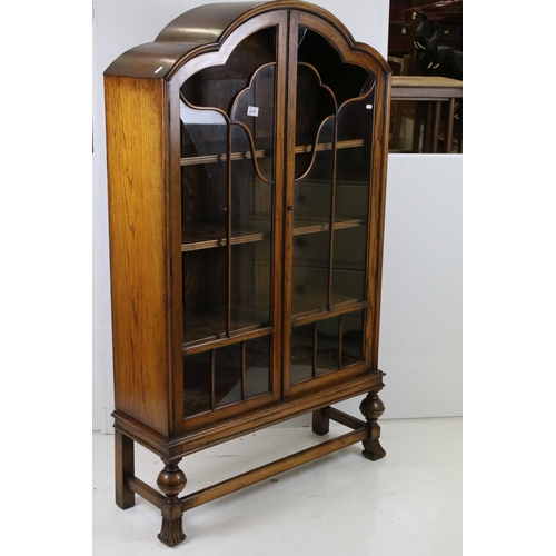 688 - Art Deco Oak Display Cabinet with cloud shaped top, twin glazed doors (a/f) opening to three adjusta... 