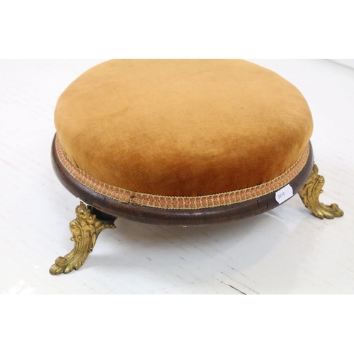 692 - 19th century Circular Footstool, gold coloured upholstered top raised on a wooden frame with three g... 