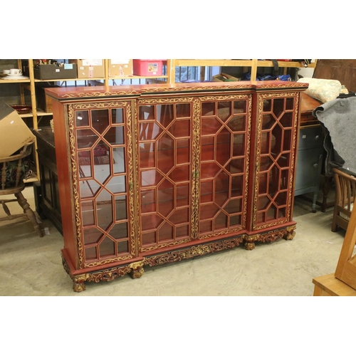 693 - Red Lacquered and Gilt decorated Inverted Breakfront Display Cabinet in the Chinese manner, the cent... 