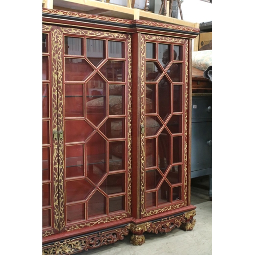 693 - Red Lacquered and Gilt decorated Inverted Breakfront Display Cabinet in the Chinese manner, the cent... 