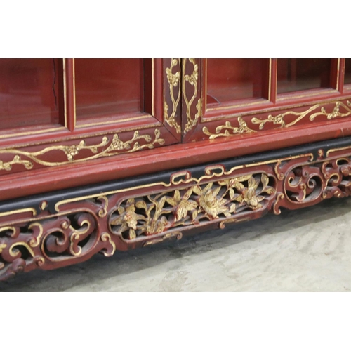 693 - Red Lacquered and Gilt decorated Inverted Breakfront Display Cabinet in the Chinese manner, the cent... 