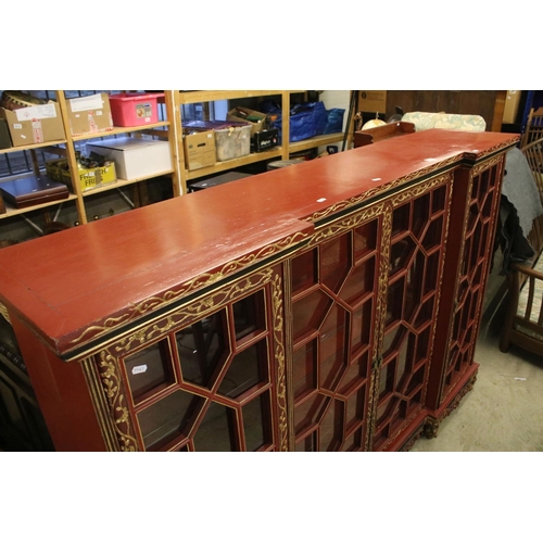 693 - Red Lacquered and Gilt decorated Inverted Breakfront Display Cabinet in the Chinese manner, the cent... 