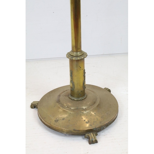 702 - Late 19th / Early 20th century Brass Standard Reading Lamp, the circular base with three scroll feet