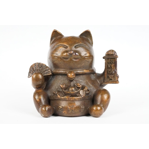 220 - An ornamental Japanese bronze 招き猫 / maneki-neko (waving / beckoning) lucky cat talisman.