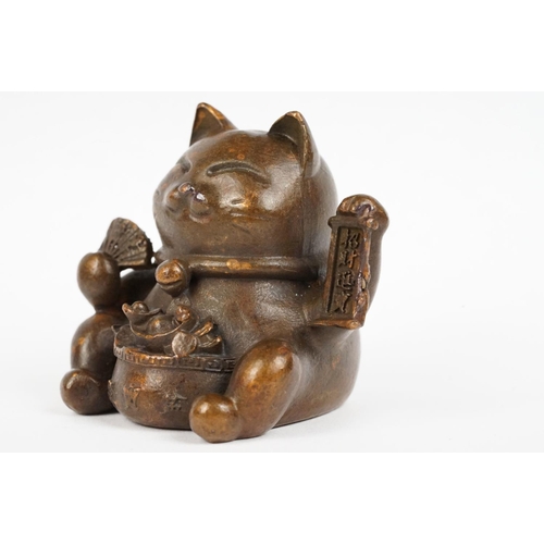 220 - An ornamental Japanese bronze 招き猫 / maneki-neko (waving / beckoning) lucky cat talisman.