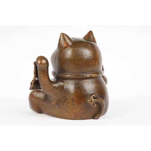 220 - An ornamental Japanese bronze 招き猫 / maneki-neko (waving / beckoning) lucky cat talisman.