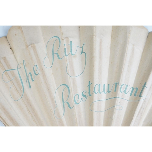 225 - An antique French paper fan with figural decoration on wooden frame, marked the Ritz Restaurant to v... 