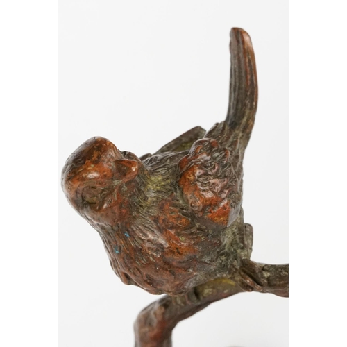 228 - A Chinese bronze ornamental bird on cherry blossom branch.