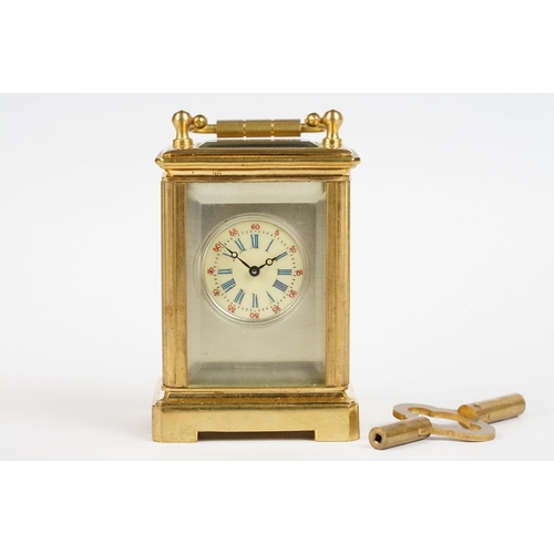 232 - A miniature antique brass cased carriage clock with enamel panels with cherub decoration.