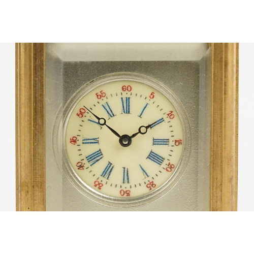 232 - A miniature antique brass cased carriage clock with enamel panels with cherub decoration.