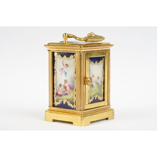 232 - A miniature antique brass cased carriage clock with enamel panels with cherub decoration.