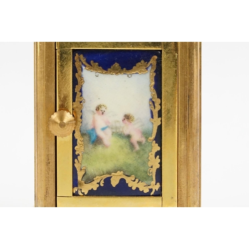 232 - A miniature antique brass cased carriage clock with enamel panels with cherub decoration.