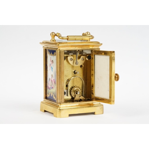 232 - A miniature antique brass cased carriage clock with enamel panels with cherub decoration.