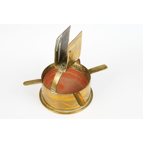 289 - A trench art ashtray matchbox holder combination made from a brass artillery round together with an ... 