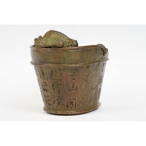 293 - A Chinese cast metal incense burner in the form of Chan Chuy in the bath.