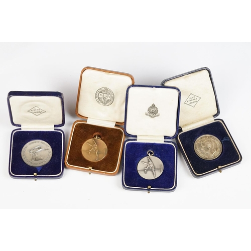 299 - A collection of four cased coins and sporting medals.