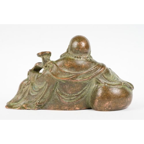 308 - An oriental copper buddha figure, stands approx 6cm in height.