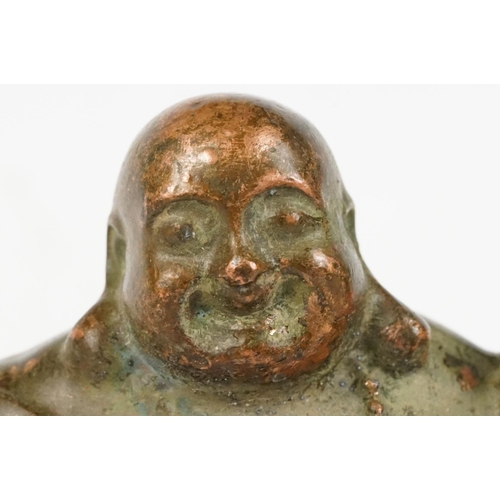 308 - An oriental copper buddha figure, stands approx 6cm in height.