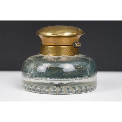 311 - A collection of eight vintage glass inkwells to include a blue glass example.