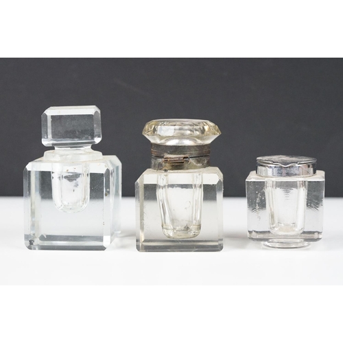 311 - A collection of eight vintage glass inkwells to include a blue glass example.