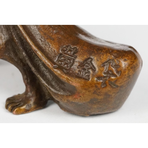 315 - An ornamental chinese bronze lucky fortune rat with bag.