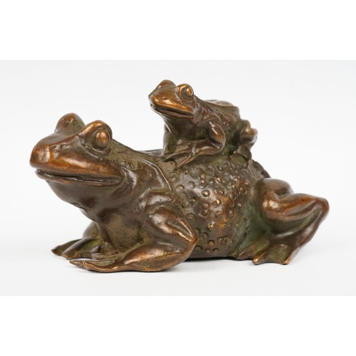 317 - An ornamental Chinese copper figure of a toad carrying a smalller toad.