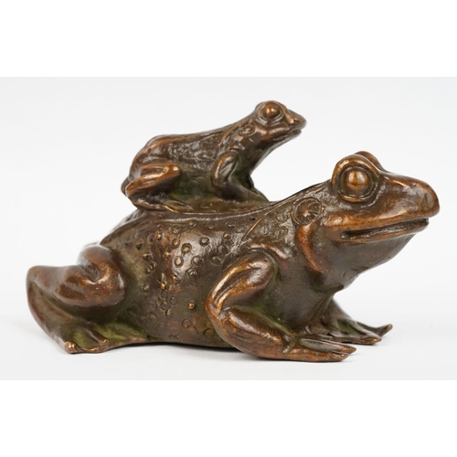 317 - An ornamental Chinese copper figure of a toad carrying a smalller toad.