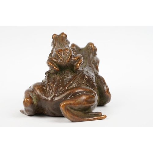 317 - An ornamental Chinese copper figure of a toad carrying a smalller toad.