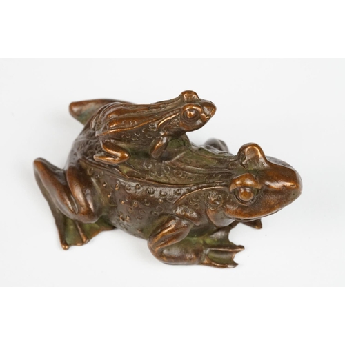 317 - An ornamental Chinese copper figure of a toad carrying a smalller toad.