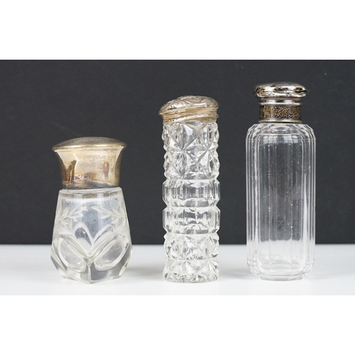 321 - A small group of mixed collectables to include glass scent bottles to sterling silver lids, banded a... 