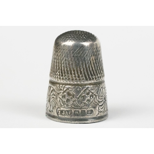 247 - Silver thimble containing smaller white metal thimble, in original silk and velvet lined leather cov... 