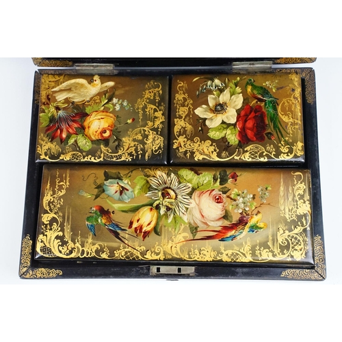 145 - 19th century black lacquered games box, the lid painted with exotic birds amongst flowers, with thre... 