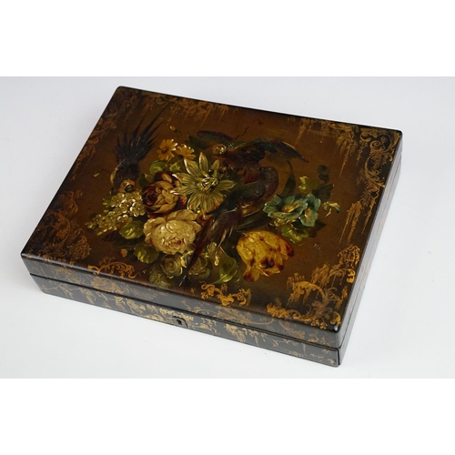 145 - 19th century black lacquered games box, the lid painted with exotic birds amongst flowers, with thre... 