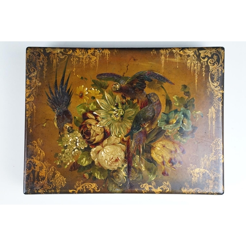 145 - 19th century black lacquered games box, the lid painted with exotic birds amongst flowers, with thre... 