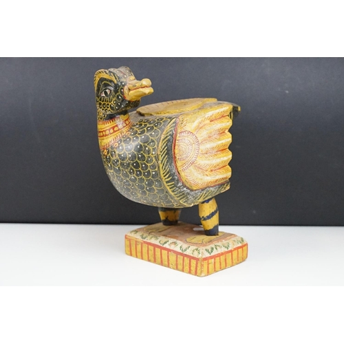 184 - South East Asian carved wooden duck sculpture with painted decoration, raised on a rectangular base.... 