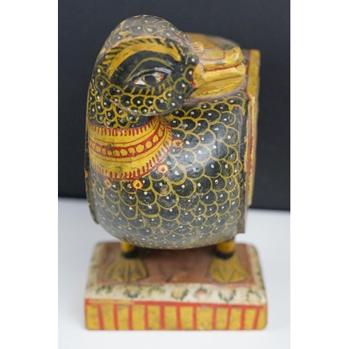 184 - South East Asian carved wooden duck sculpture with painted decoration, raised on a rectangular base.... 