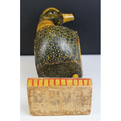 184 - South East Asian carved wooden duck sculpture with painted decoration, raised on a rectangular base.... 