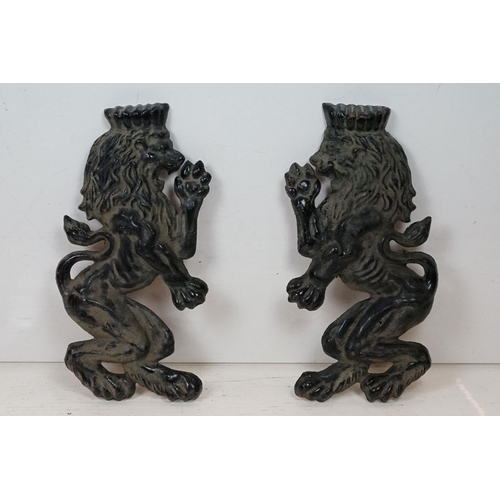 186 - Pair of cast iron rampant lion black painted wall plaques, approx 55cm tall