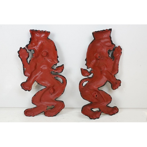 186 - Pair of cast iron rampant lion black painted wall plaques, approx 55cm tall