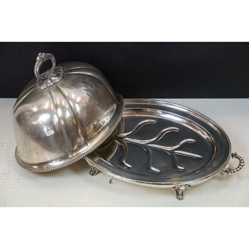 213 - Silver plated cloche of typical domed form with cast scroll handle, together with a silver plated wa... 