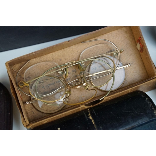 358 - A collection of cased vintage spectacles / eye glasses.