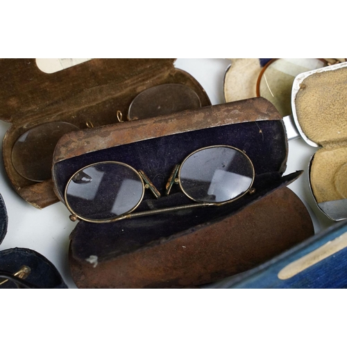 358 - A collection of cased vintage spectacles / eye glasses.