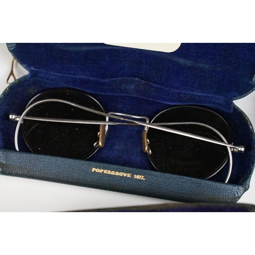 358 - A collection of cased vintage spectacles / eye glasses.