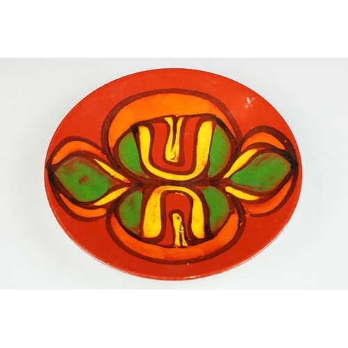 65 - Poole Pottery Delphis red ground shallow dish, appox 26.5cm diameter, monogram to reverse, shape no.... 