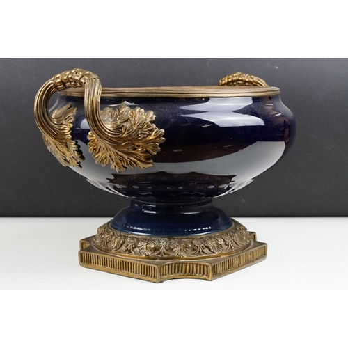 70 - Cobalt blue porcelain & bronze twin-handled centre bowl, with reeded bronze rim, raised on a quatref... 