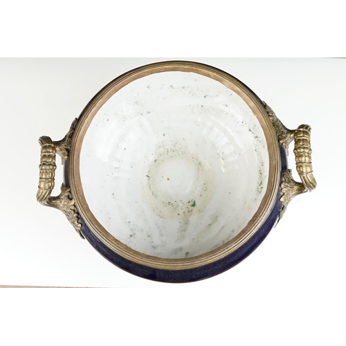 70 - Cobalt blue porcelain & bronze twin-handled centre bowl, with reeded bronze rim, raised on a quatref... 