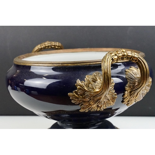 70 - Cobalt blue porcelain & bronze twin-handled centre bowl, with reeded bronze rim, raised on a quatref... 